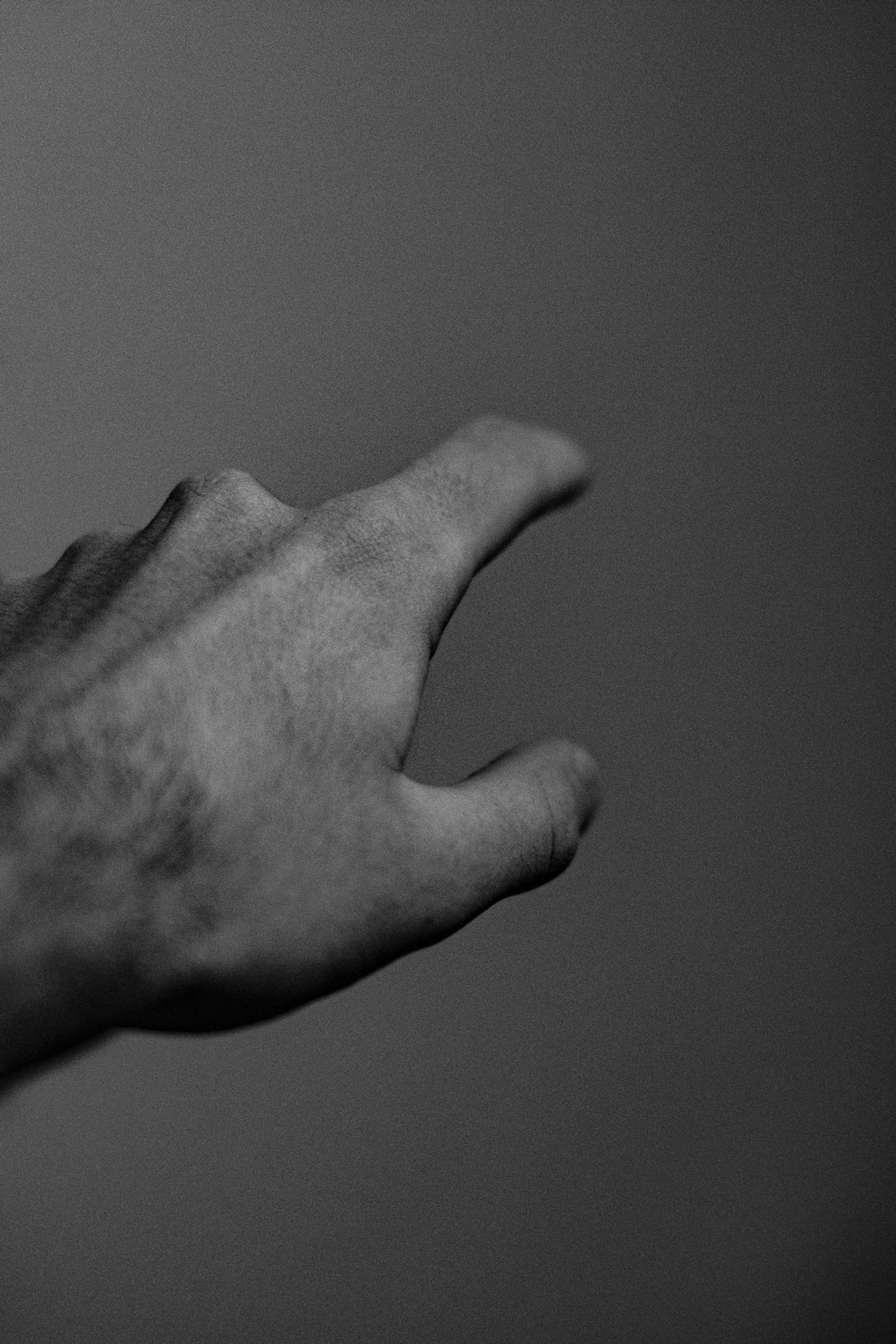 grayscale photography of pointing person