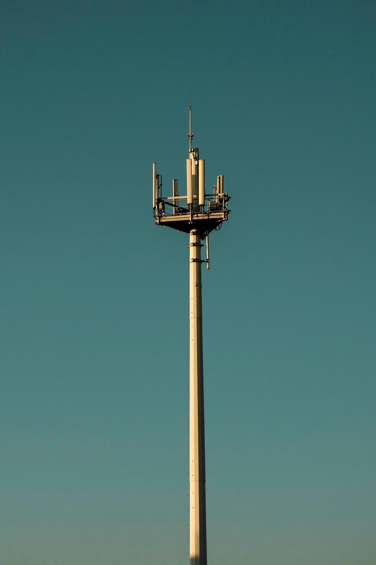 a tall tower with a cell phone on top of it