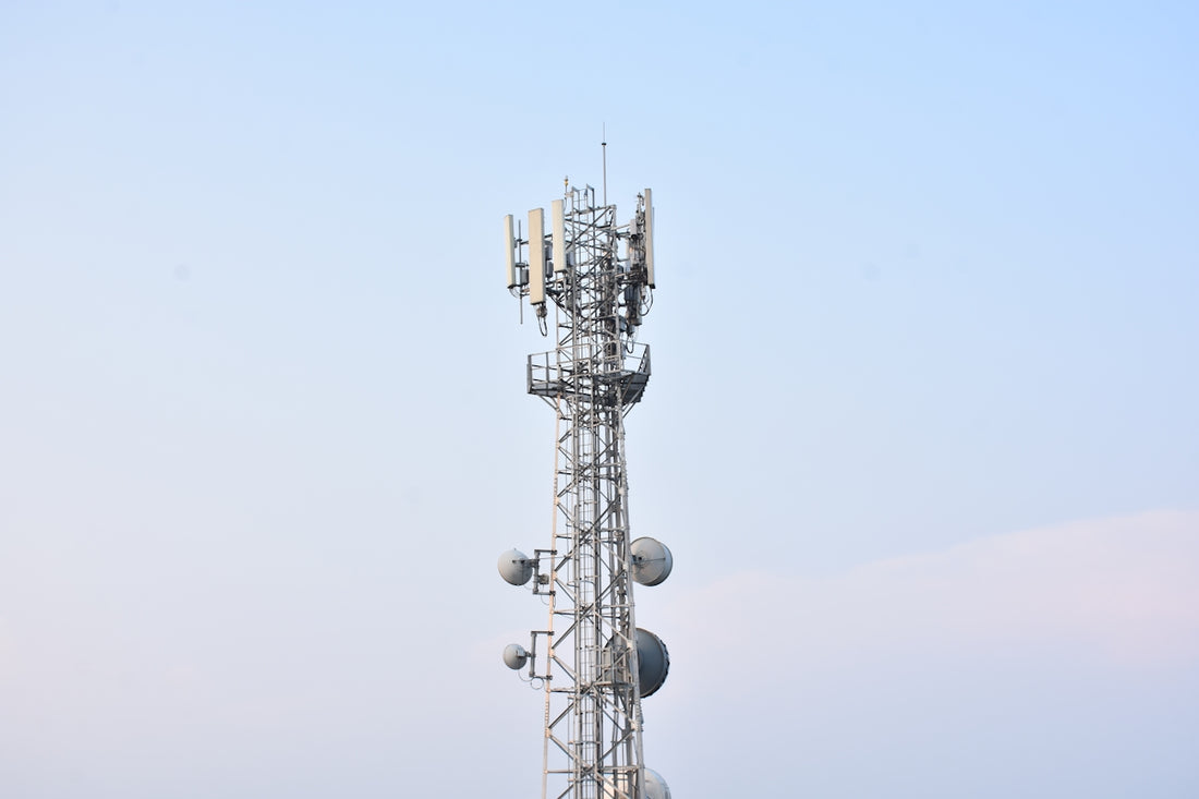 a tall tower with several cell phones on top of it