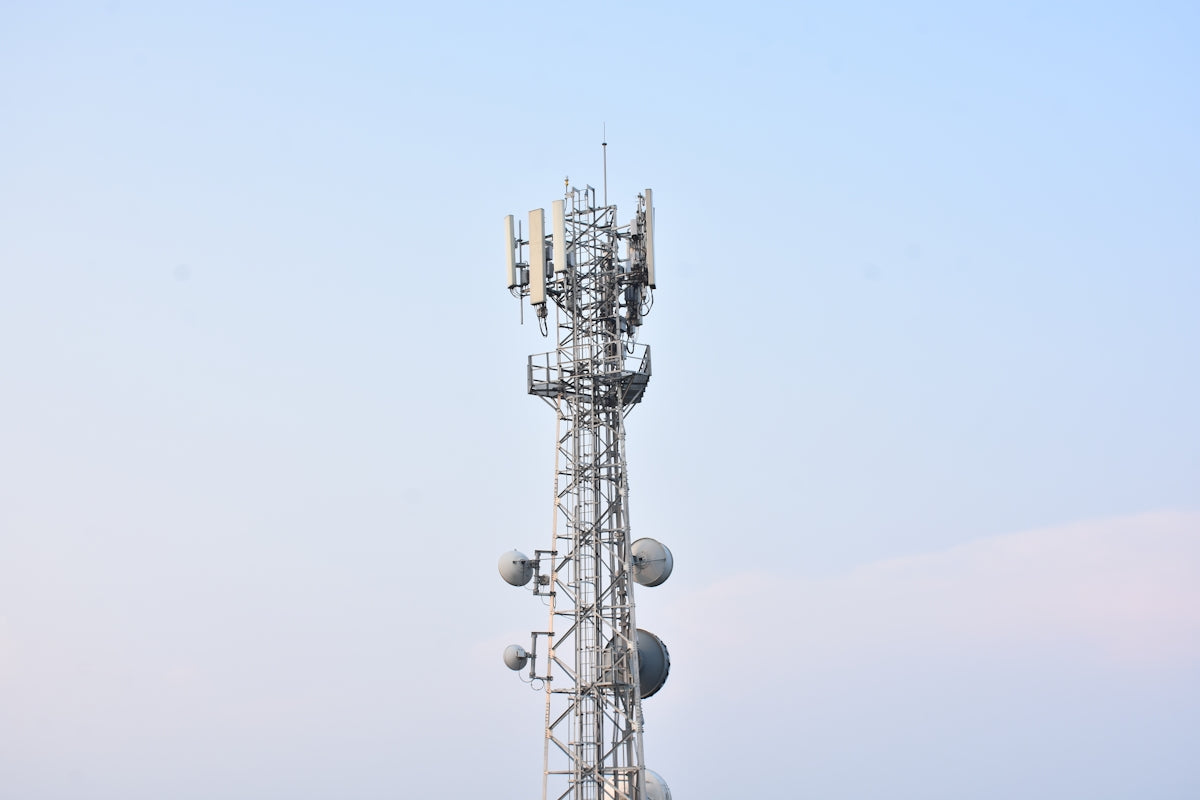 a tall tower with several cell phones on top of it