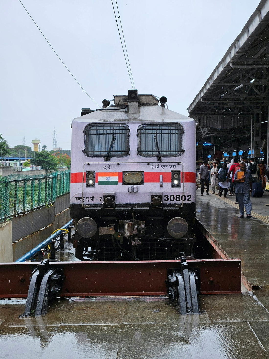 A train on a train track in the rain