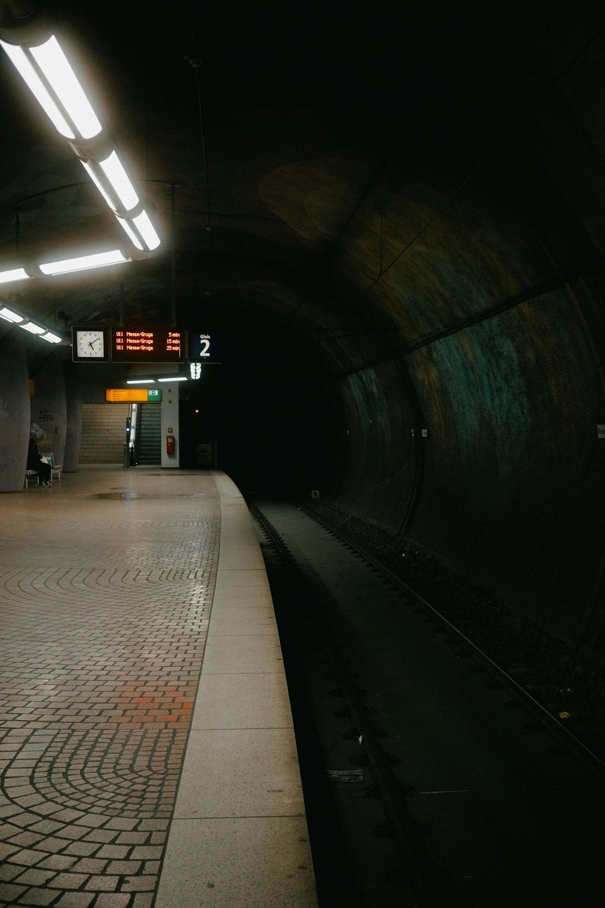A dark and empty subway platform.
