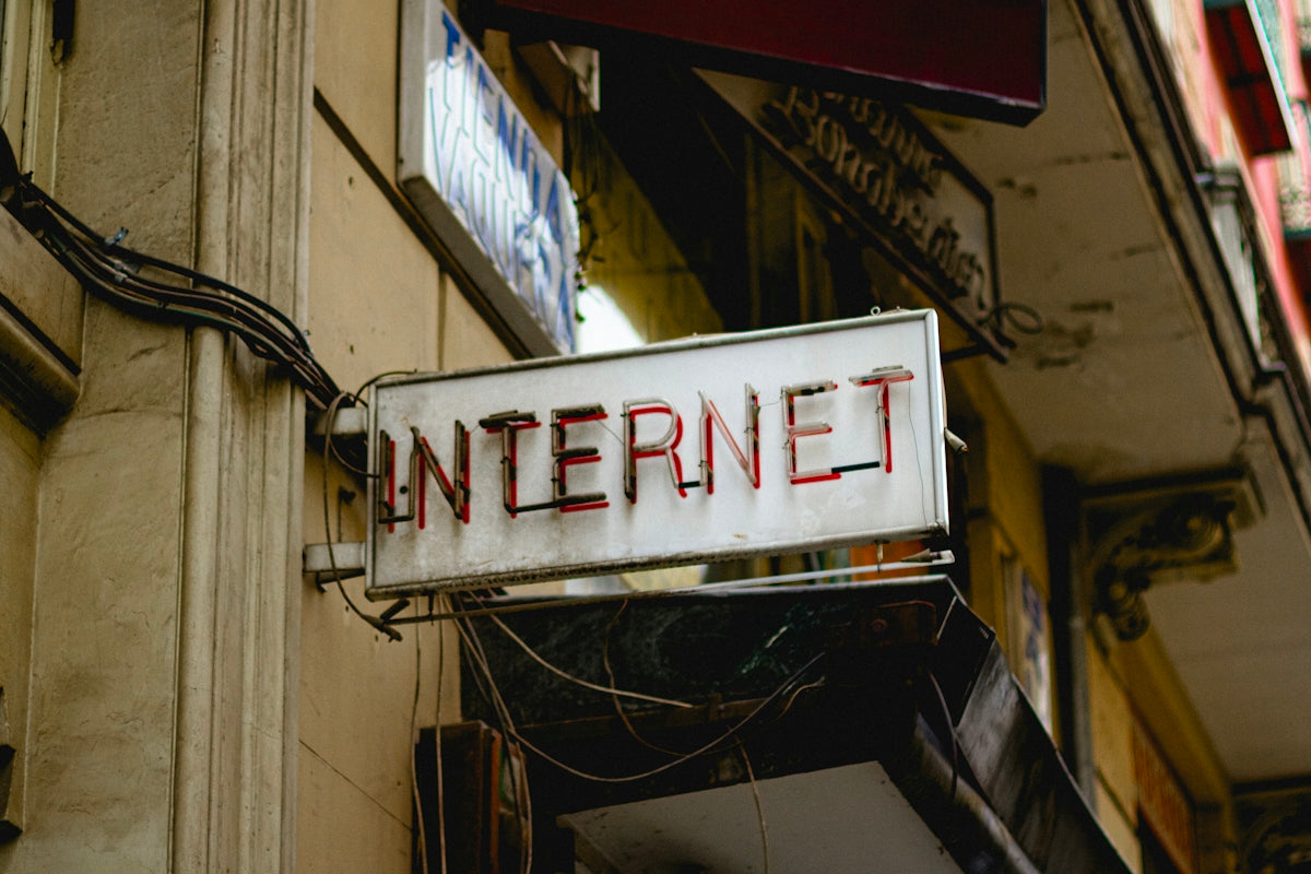 An internet sign hangs on a building's exterior.